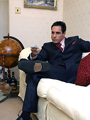 Horny Marcello wearing a pin stripe suit with bare feet and masturbating