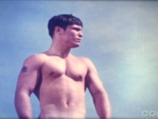 Beautiful vintage boy wanders the beach in the nude