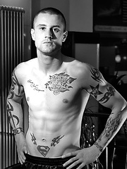 The heavily tattooed tough guy demurely stands on the scales covering his cock and balls by Ruggerbugger image #5