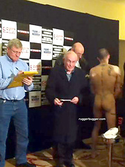The heavily tattooed tough guy demurely stands on the scales covering his cock and balls by Ruggerbugger image #5