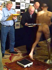 The heavily tattooed tough guy demurely stands on the scales covering his cock and balls by Ruggerbugger image #5