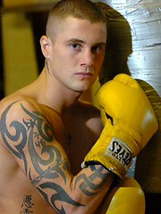 The heavily tattooed tough guy demurely stands on the scales covering his cock and balls by Ruggerbugger image #5