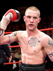 The heavily tattooed tough guy demurely stands on the scales covering his cock and balls by Ruggerbugger image #5