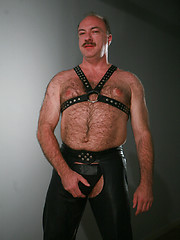 Jeremy Todd in a lether gear strokes his uncut mature cock by Pantheon Bear image #8