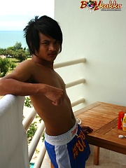 Cute gay Thai kickboxer posing and stripping