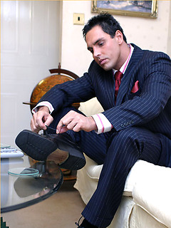 Horny Marcello wearing a pin stripe suit with bare feet and masturbating