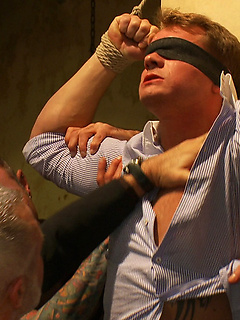 A stud endures brutal face and ass fucking by a crowd of strangers while suspended upside down. by Bound in Public by Bound in Public image #1