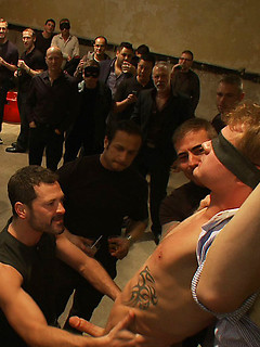 A stud endures brutal face and ass fucking by a crowd of strangers while suspended upside down. by Bound in Public by Bound in Public image #2