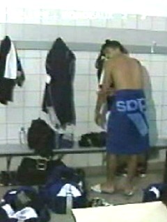 EricDeman catches a hot footballer in the locker room adjusting his towel just before being interviewed and inadvertently revealing his big wet cock. by Eric Deman by Eric Deman image #1