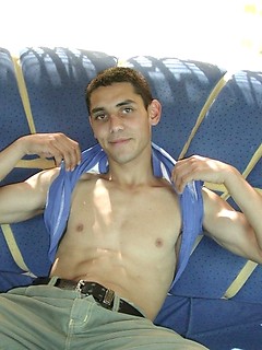 Hot twink covers his smooth stomach with a hot gooey load.