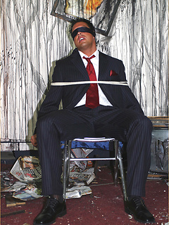 Marcello is tied up in a burnt out house by a masked man, who then apologises by licking his feet and sucking his big hard cock by With Marcello by With Marcello image #1